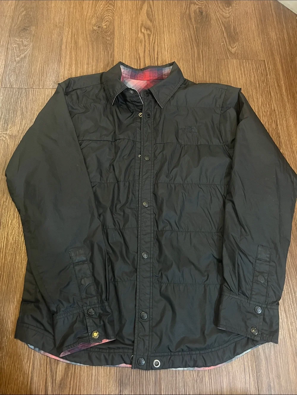 The North Face Black Jacket with Red & Blue Plaid Lining can be worn inside-out